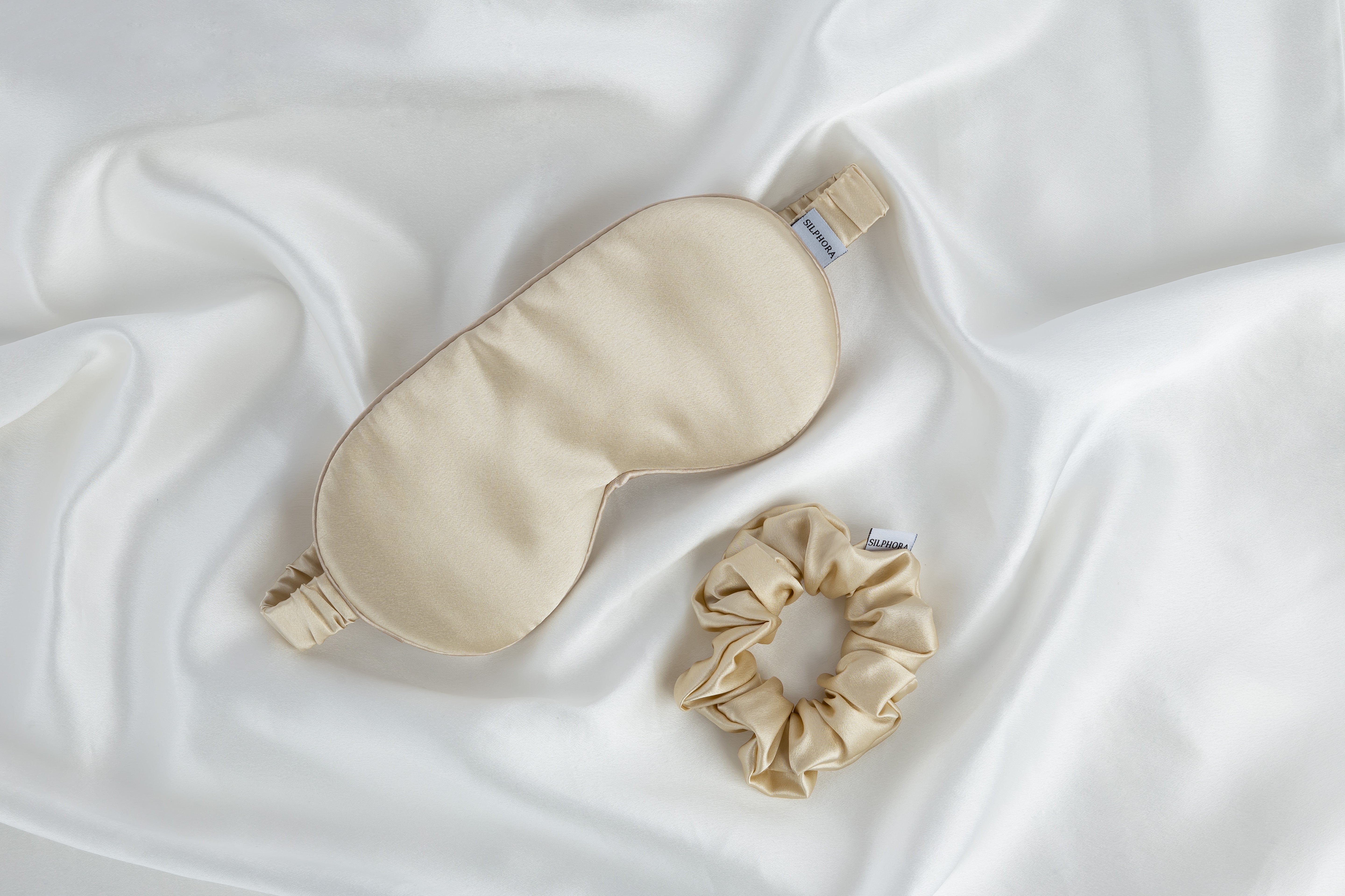 Champagne Glow silk gift set including pillowcase, eye mask, and scrunchie, made from 100% mulberry silk for smooth hair and glowing skin, presented in an elegant gift box
